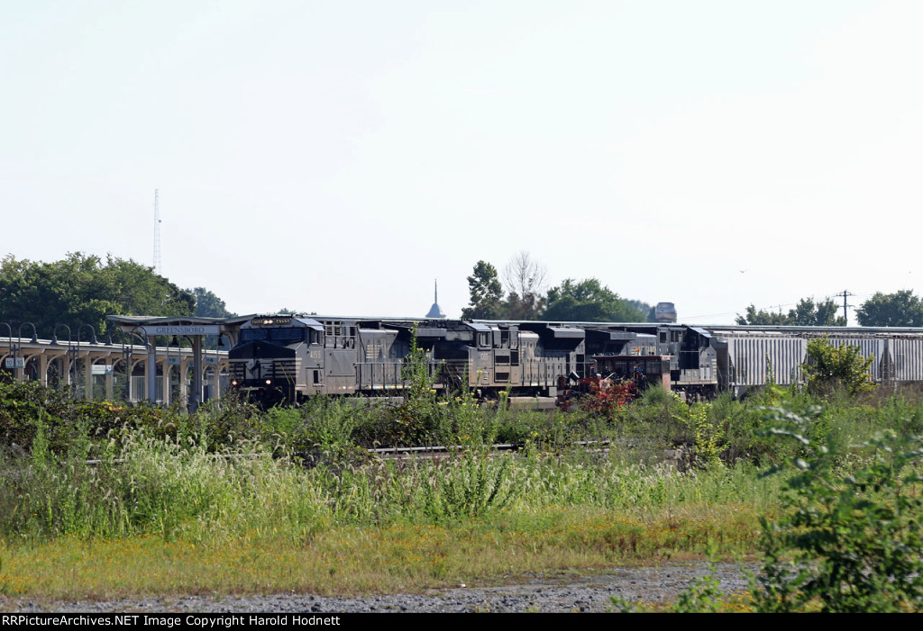 NS 4155 leads train 351 past the station and overgrown A&Y yard